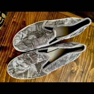 Grey soft shoes. Look like Vans.